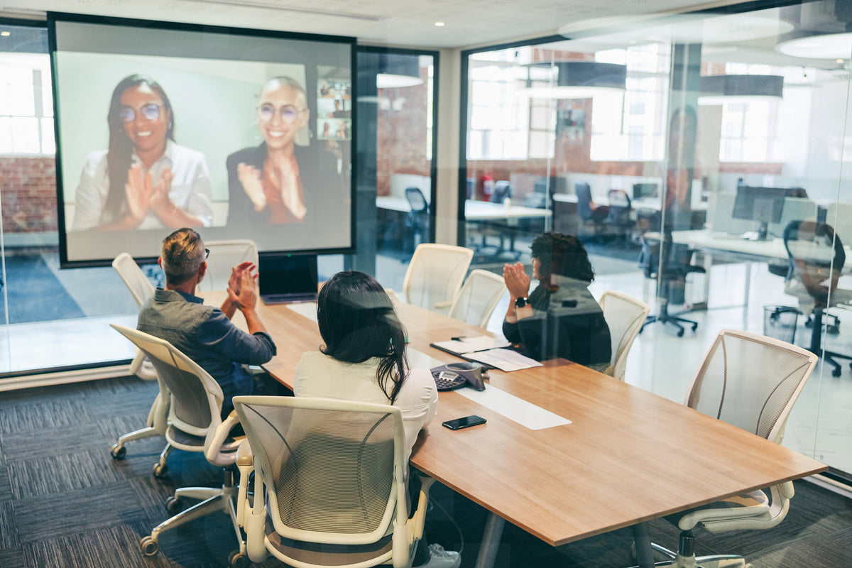 Creative businesspeople clapping during a video conference – Jacob Lund ...