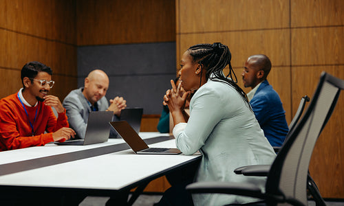 Diverse team in collaborative office meeting discussing ideas