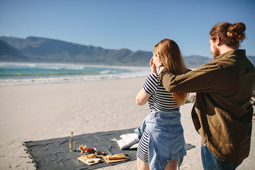 Boyfriend giving surprise to his girlfriend at the beach