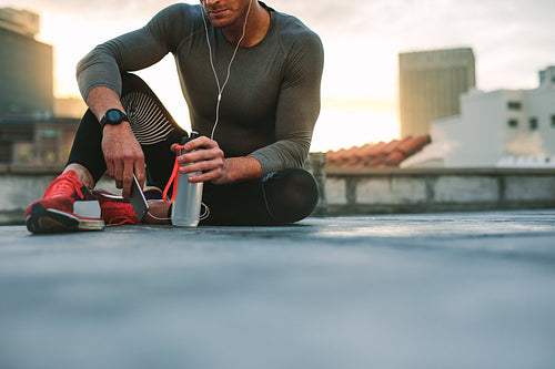 Man taking a break during workout listening to music