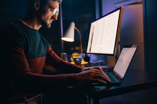 Digital marketing professional working on his laptop in his home office