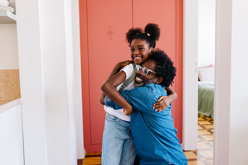 A loving goodbye: Father and daughter share a hug before school