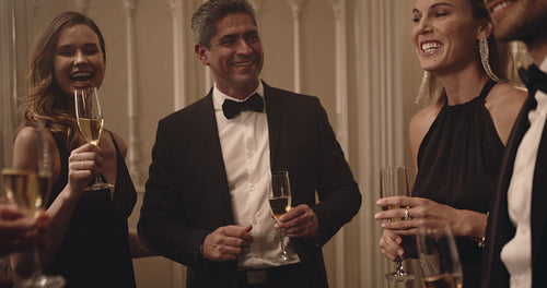 Group of friends celebrating with drinks at a party