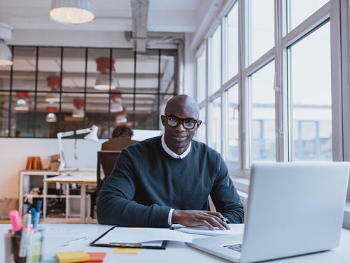 African businessman working in modern office
