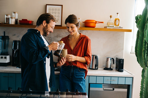 Couple enjoy coffee together in modern kitchen