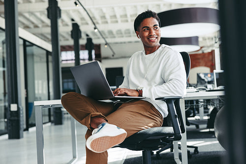 Cheerful software developer smiling in an office