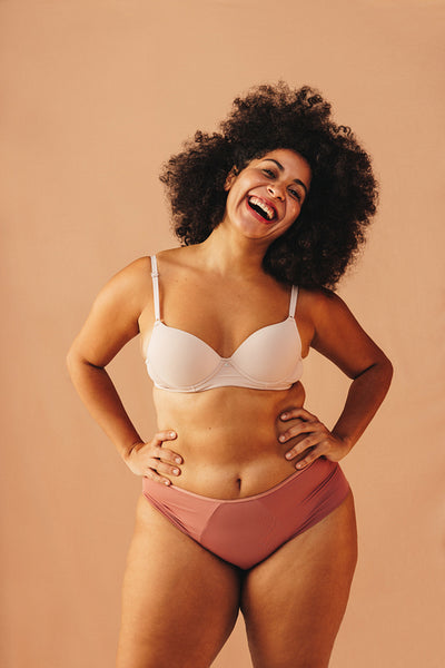 Body confident young woman smiling happily in underwear