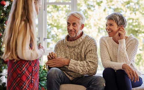 Grandparents playing games with daughter at home