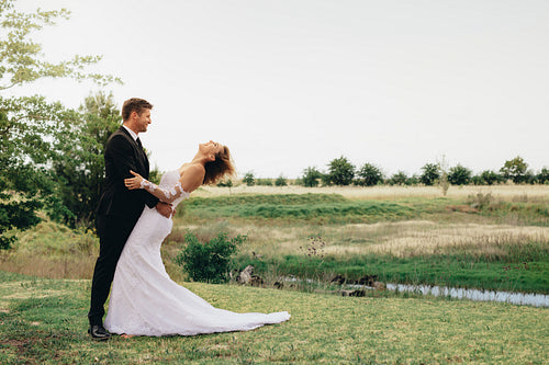 Newlyweds on wedding day outdoors