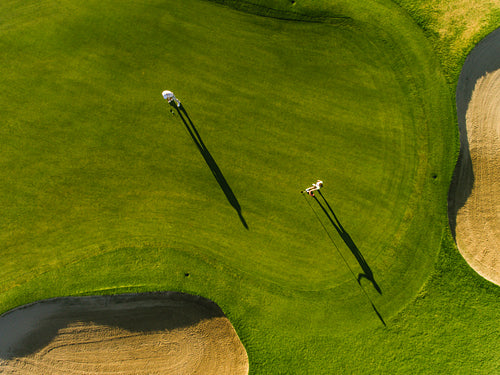 Professional golfers playing on putting green