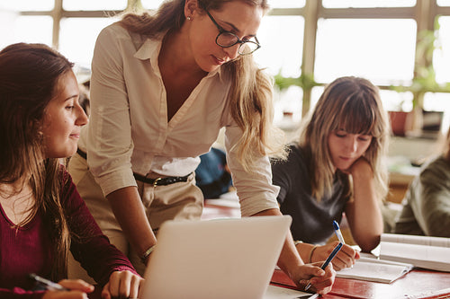 Teacher helping students study