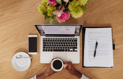 Woman  entrepreneur working with coffee in hand