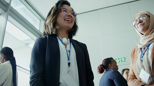 Diverse professional women smiling and actively participating in a business discussion