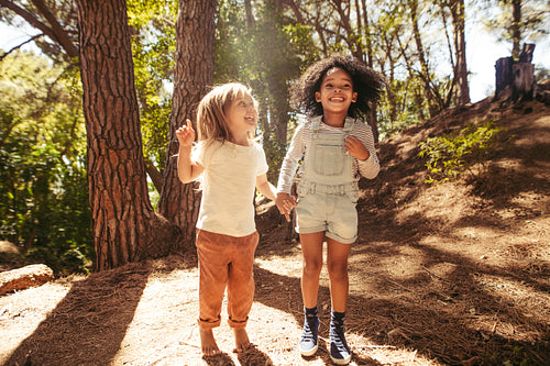Smiling girls having fun in forest