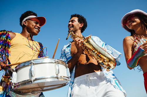 Friends celebrate carnival with drums and sax