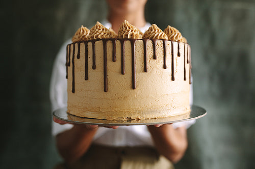 Baker showing a tasty cake