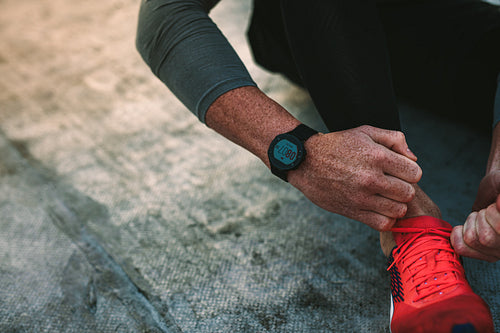 Top view of a man tying shoe lace