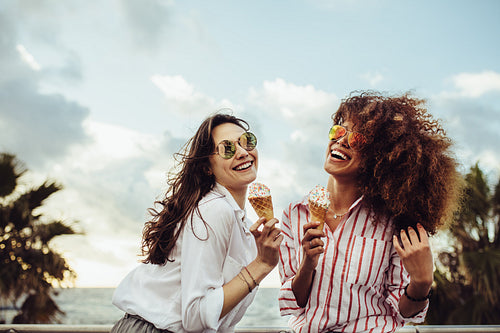 Girls having ice cream outdoors
