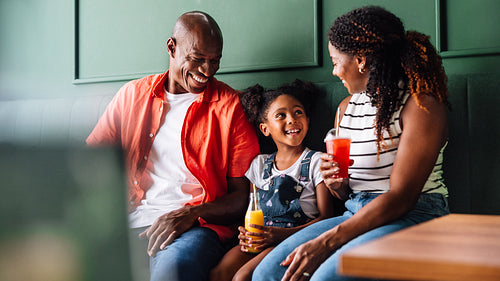 Happy family enjoying fun time together in a cafe