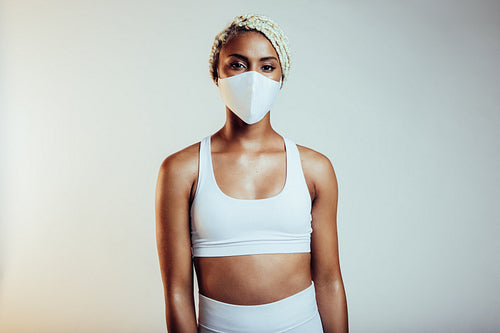Fit african woman with face mask