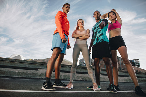 Multi-ethnic fitness group standing together in the city