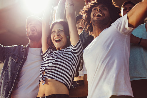 Group of soccer fans cheering for their team