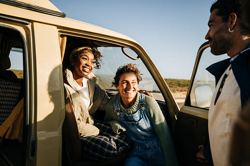 Bright greetings: Friends smile at the camper door during a stop