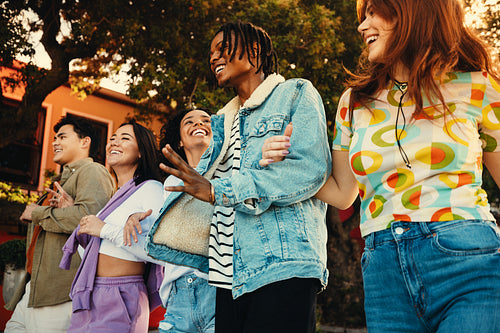 Group of friends laughing and enjoying summer outdoors