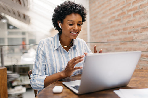 Ethnic small business owner having a video call in a warehouse