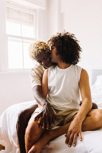 Male lovers being romantic in their bedroom