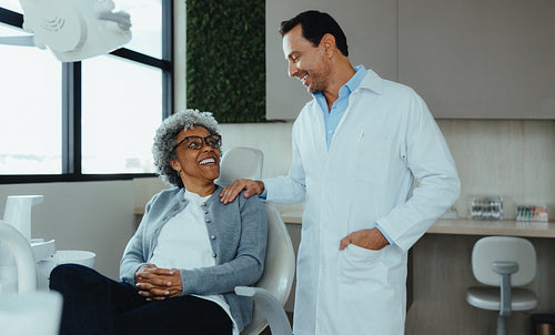 Patient listens as dentist offers chairside support in a modern clinic