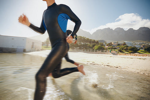 Triathletes rushing into the water