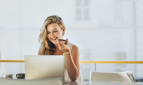 Businesswoman making phone call from cafe