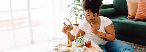 Beautiful healthy woman doing skin care routine at home