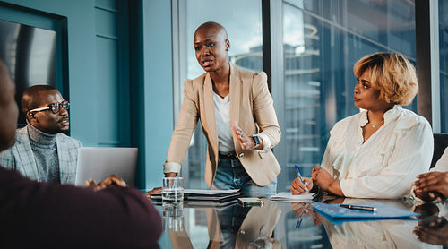 Successful corporate team of professionals collaborating in office meeting