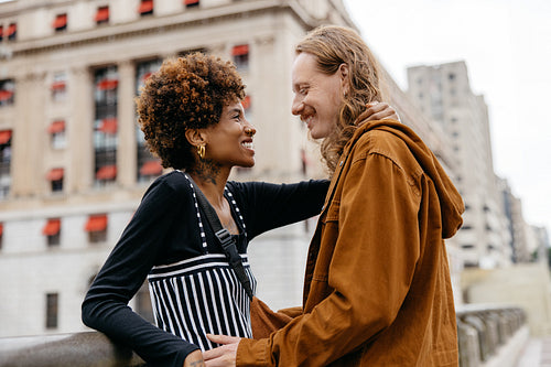 Affectionate couple embracing and sharing a joyous moment in the city