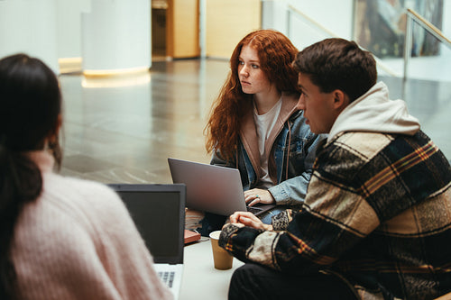 Group of students having discussion in college