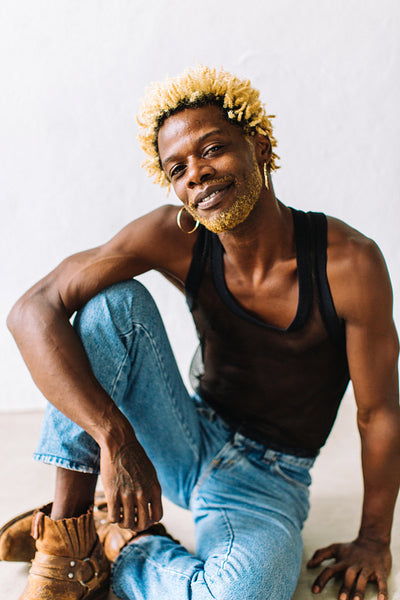 Confident queer man posing alone in a studio