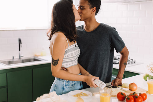 Lovers bonding in the kitchen