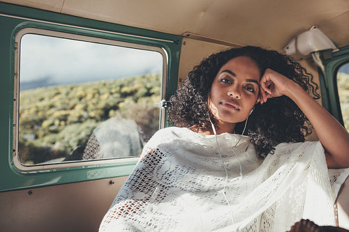 Woman on road trip listening music