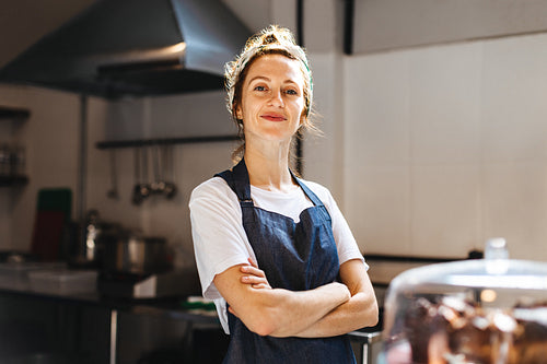 Female small business owner standing in her coffee shop