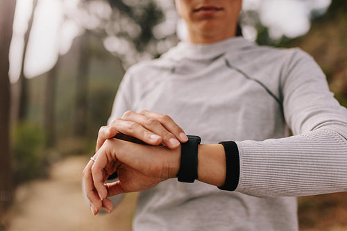 Runner checking fitness progress on her smart watch