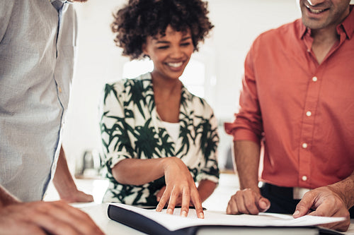Couple with estate agent discussing property documents