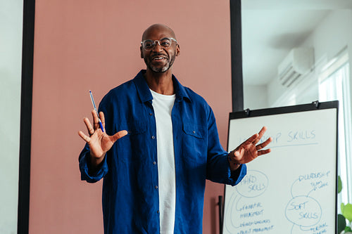 Businessman giving a training presentation in a casual boardroom setting
