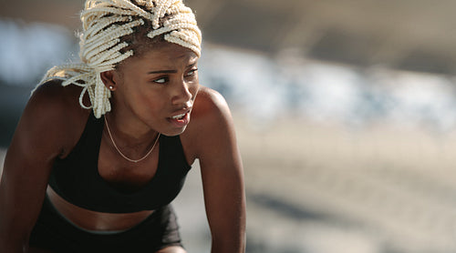 Female athlete relaxing after training