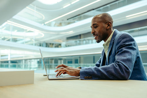 Businessman in modern office using laptop computer