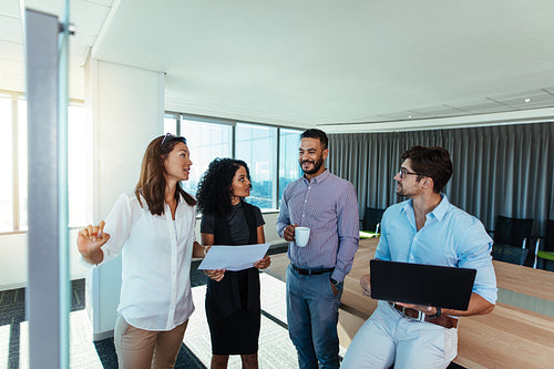 Entrepreneurs discussing business ideas in office.