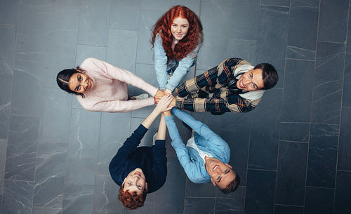 Students with hands stacked together