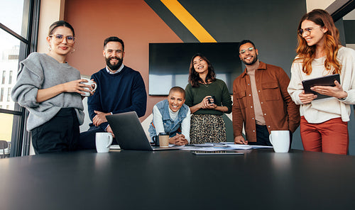 Young businesspeople smiling happily in a boardroom