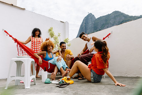 Group of five friends relaxing together on a rooftop in Rio de Janeiro